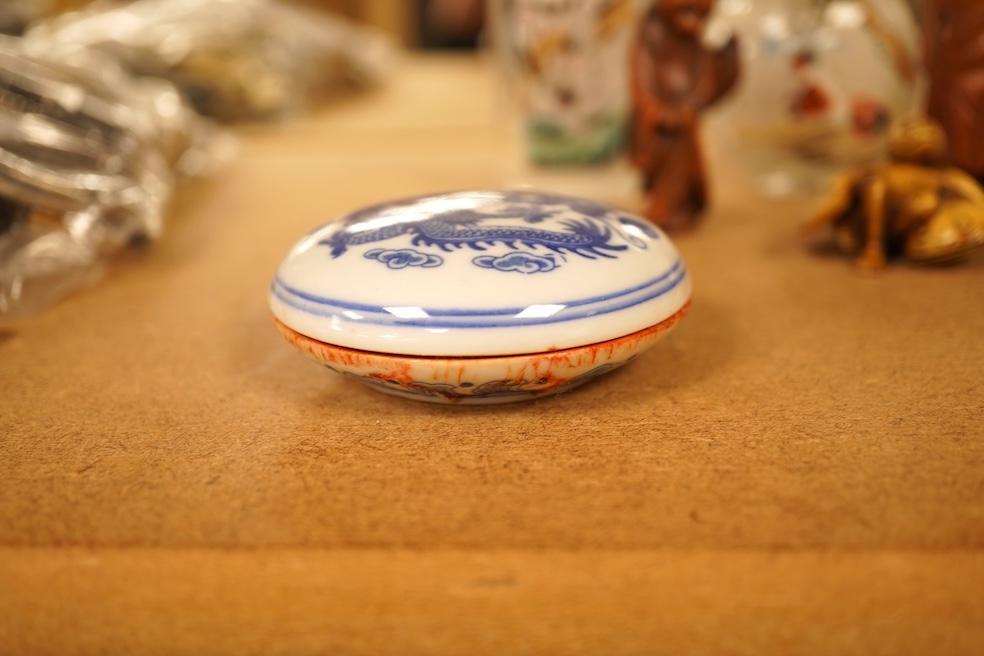 A collection of Chinese and Japanese items comprising snuff bottles, blue and white seal box and netsukes, largest 9cm high